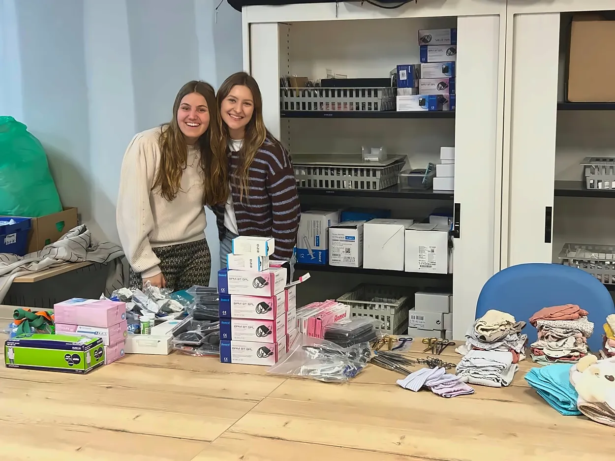 Two women next to a table with medical supplies during the Tropical Medicine Internship