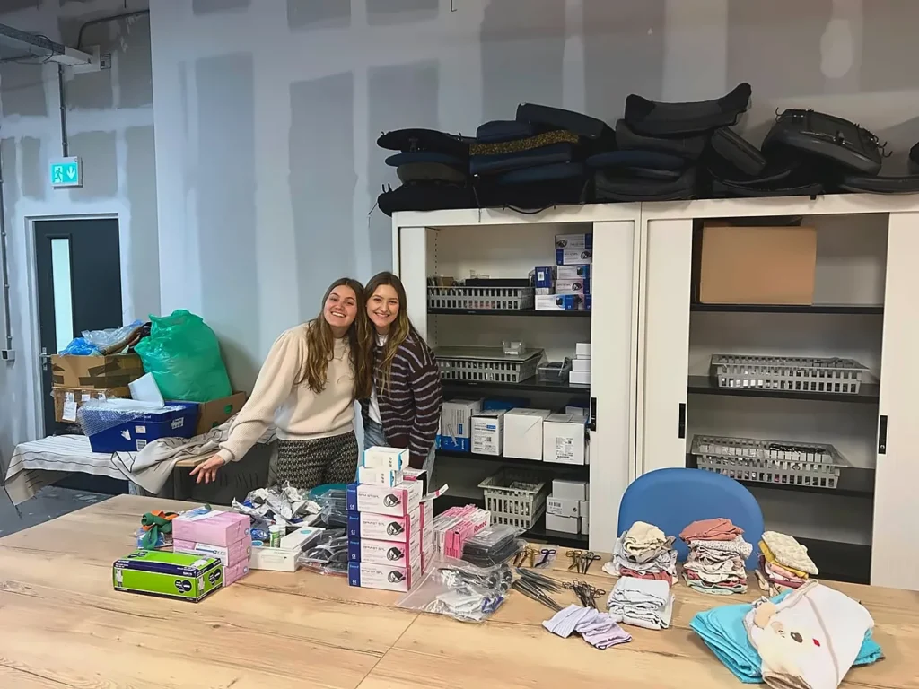Two women next to a table with medical supplies during the Tropical Medicine Internship